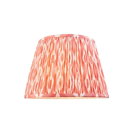 Endon Brenwell 35cm tapered lamp shade in pleated coral pink faux silk with ikat pattern and taped edges, shown on a plain white background.