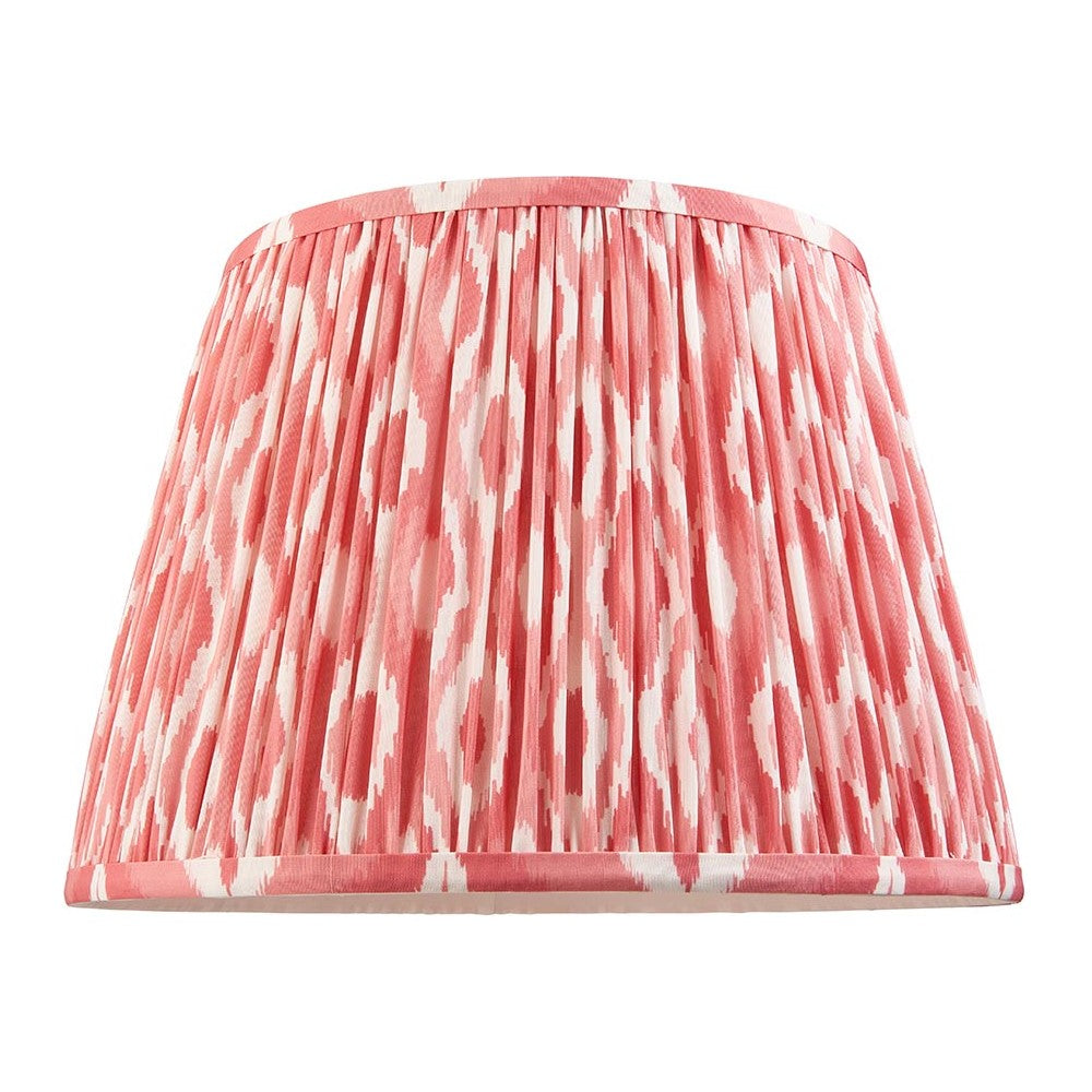 Endon Brenwell 35cm tapered lamp shade in coral pink and white ikat printed faux silk with gathered pleats and taped edges, on a white background.