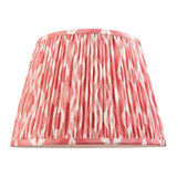 Endon Brenwell 35cm tapered lamp shade in coral pink and white ikat printed faux silk with gathered pleats and taped edges, on a white background.