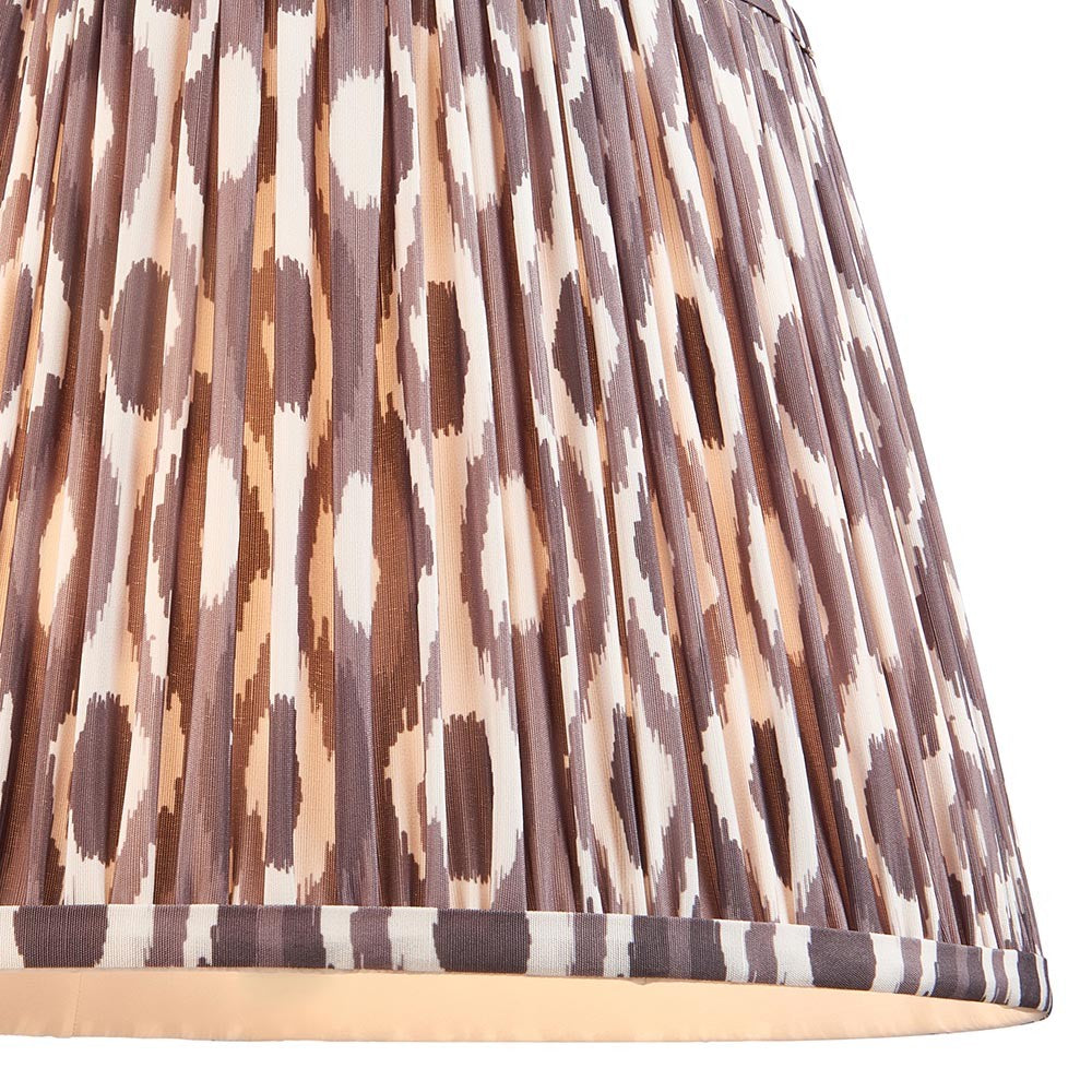 Endon Brenwell 35cm tapered lamp shade in pearl grey pleated faux silk with an ikat pattern in grey, brown and cream, shown in close-up.