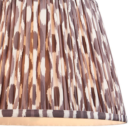 Endon Brenwell 35cm tapered lamp shade in pearl grey pleated faux silk with an ikat pattern in grey, brown and cream, shown in close-up.