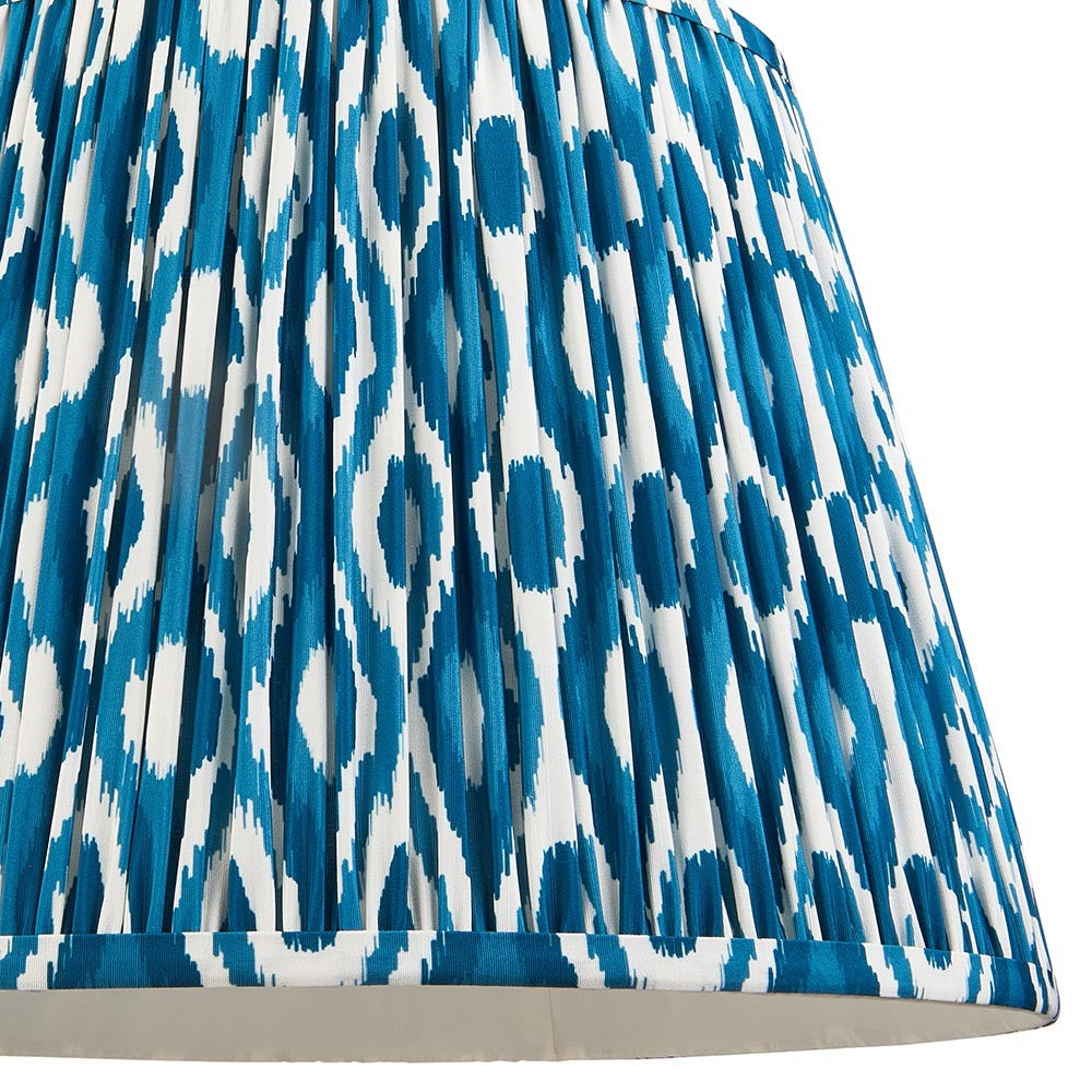 Close-up of the Endon Brenwell 40cm tapered lamp shade in marlin blue, showing pleated faux silk with a blue and white ikat pattern.