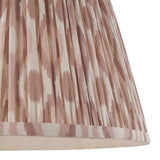Close-up of Endon Brenwell 40cm tapered lamp shade in neutral, showing pleated faux silk with a pink and cream ikat print and taped edge.