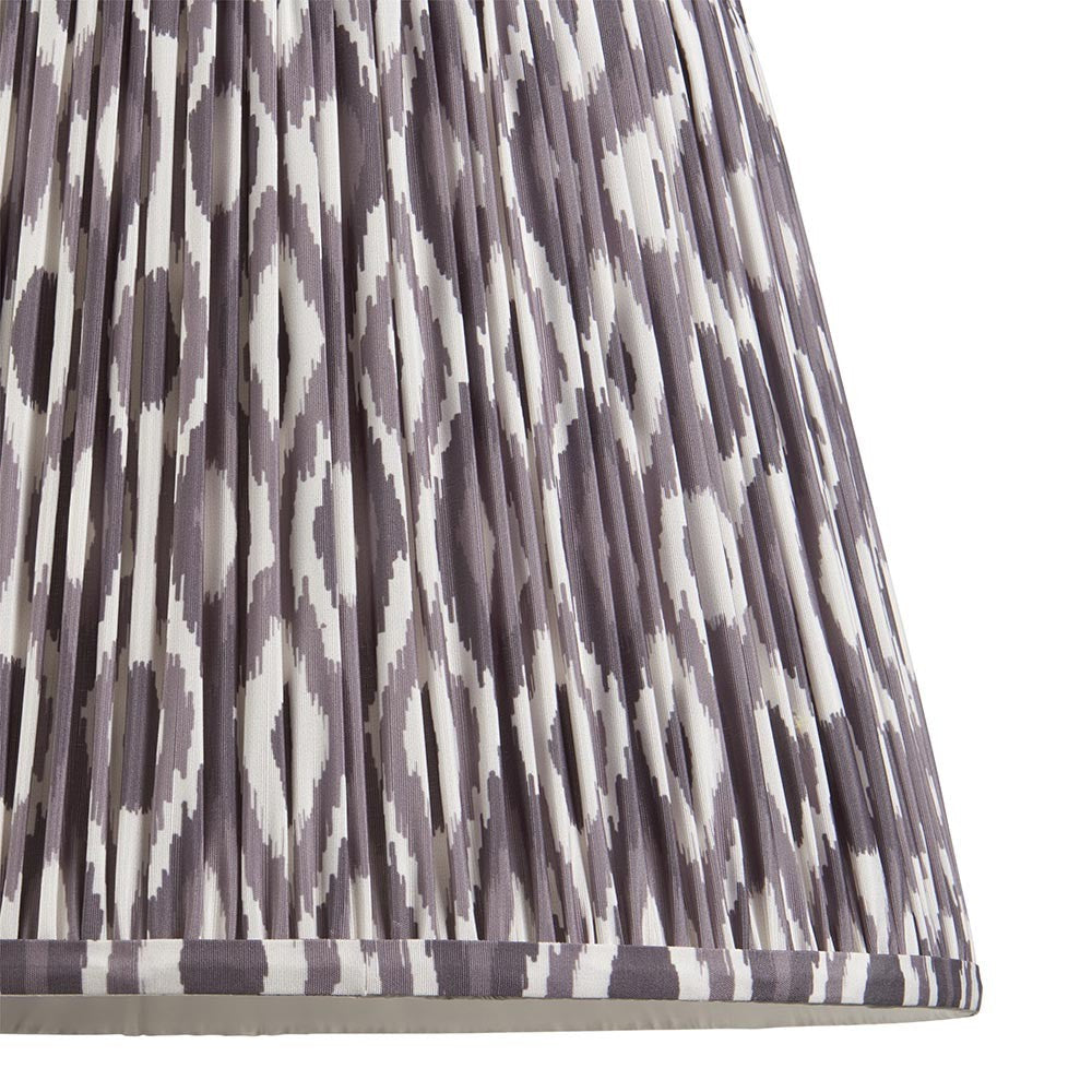 Close-up of Endon Brenwell 40cm tapered lamp shade in pearl grey, showing gathered pleated faux silk with an ikat pattern and taped edge detail.
