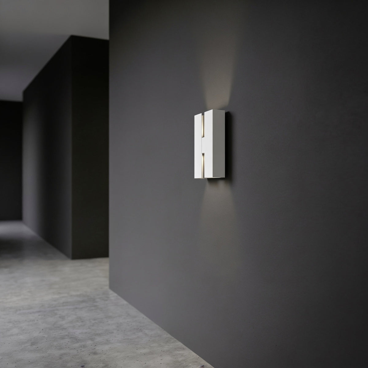 Briscola LED Outdoor Wall Light in white steel, a slim rectangular fixture with a narrow central slot, mounted on a dark wall and casting upward and downward light beams.