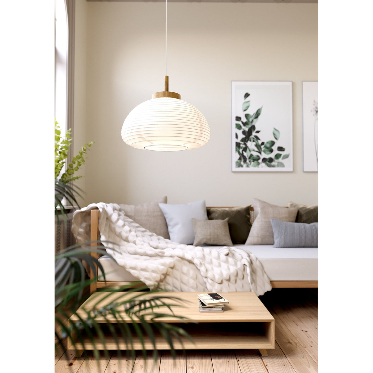 Brosmena 55cm paper pendant light with ribbed white dome shade and wood collar, hanging above a sofa and coffee table in a living room.
