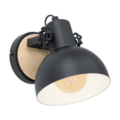 Brosora Wall Light in black and wood: a black steel dome shade with cream interior and wheel-shaped side knobs, mounted on a round wooden backplate, shown on a plain white background.