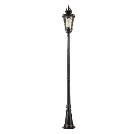 The Baltimore 1 Light Large Lamp Post in weathered bronze exhibits a tall, black vintage-style design with a decorative top and clear glass lantern. It features ornate detailing along the pole, stands on a wide base, and is accented by amber tinted blown glass for added warmth.