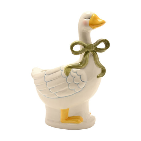 Ceramic goose planter in glossy cream with a sage green bow at the neck, yellow beak and feet, moulded wing detail, and closed eyes, shown against a plain white background.