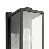 Close-up of the Budrone outdoor wall light in black steel with a box lantern frame, clear glass panels and visible E27 bulb, shown against a plain white background.