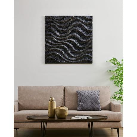 Bugrino Wall Decoration, a square black metal wall art piece with a deep wave relief and gold edge detailing, displayed above a beige sofa in a living room.
