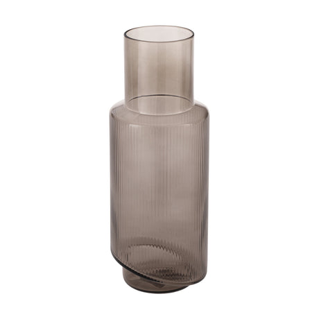 Busoro Carafe in smoked grey ribbed glass with a smooth cylindrical neck and angled, slightly offset base, shown on a plain white background.