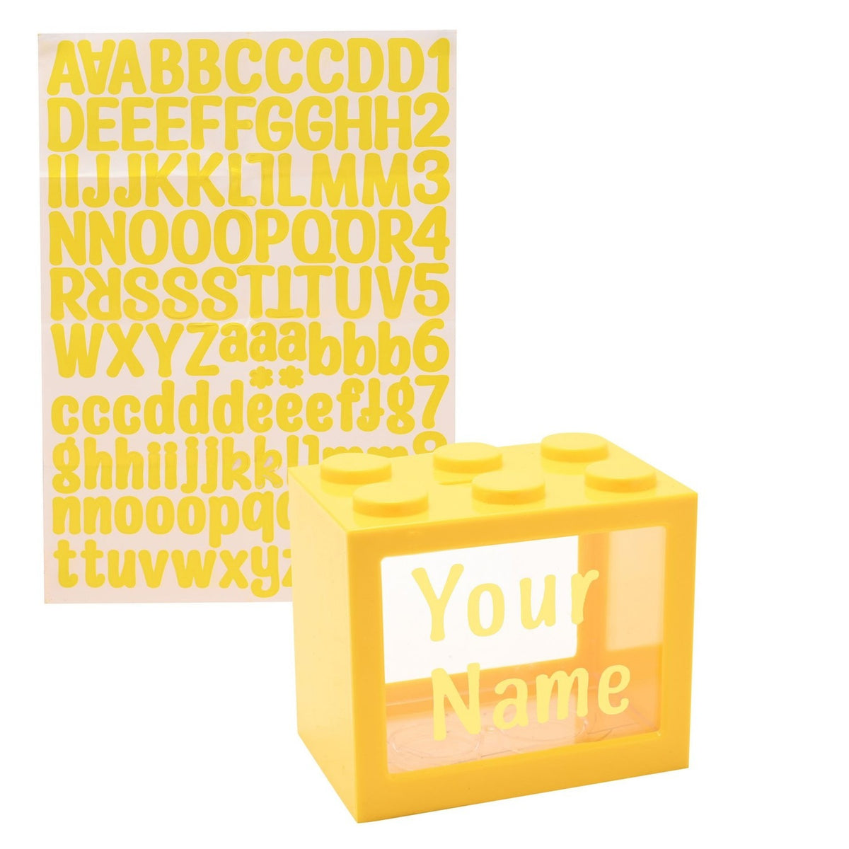 Yellow block-shaped money box with six top studs and a clear window for name stickers, shown with a matching yellow alphabet sticker sheet on white background.