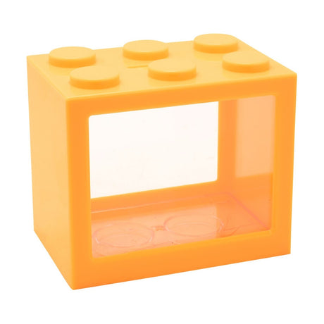 Orange plastic money box shaped like a building block with six round top studs and a clear front window, shown on a plain white background.