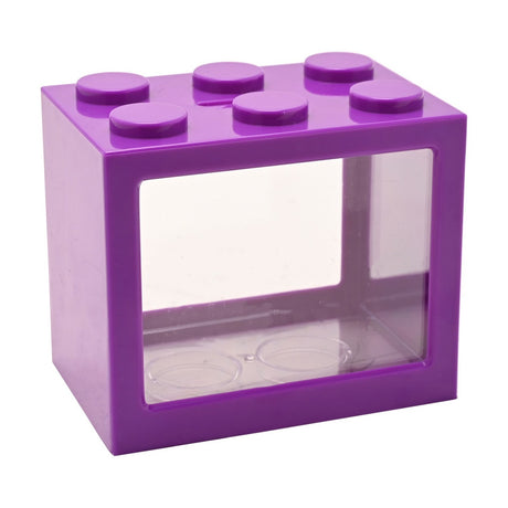 Purple plastic money box shaped like a building block with six round studs on top and a clear front window, shown on a plain white background.