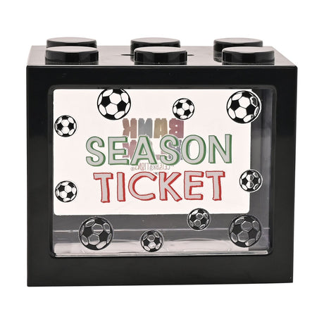 Black plastic building-brick-shaped money box with six top studs and a clear front window printed "Season Ticket" in green and red, surrounded by football graphics, on a white background.