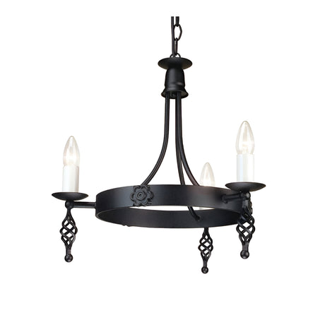 The Belfry 3 Light Chandelier - Black showcases medieval craftsmanship with its black metal design. It features three candle-shaped bulbs resting on spiral holders, all suspended from a hand-forged metal frame adorned with decorative floral details and a sturdy chain attachment.