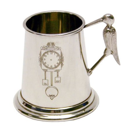 Pewter-finish baby mug with a stork-shaped handle, featuring an engraved wall clock design with lb/oz weights and a DATE pendulum, on a plain white background.