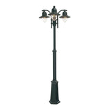 The Como 3 Light Triple Head Post - Black is a vintage-style street lamp featuring clear glass shades and ornate metal detailing on a tall, decorative post. Its IP54 rating guarantees durability for outdoor lighting, offering an elegant and classic appearance.