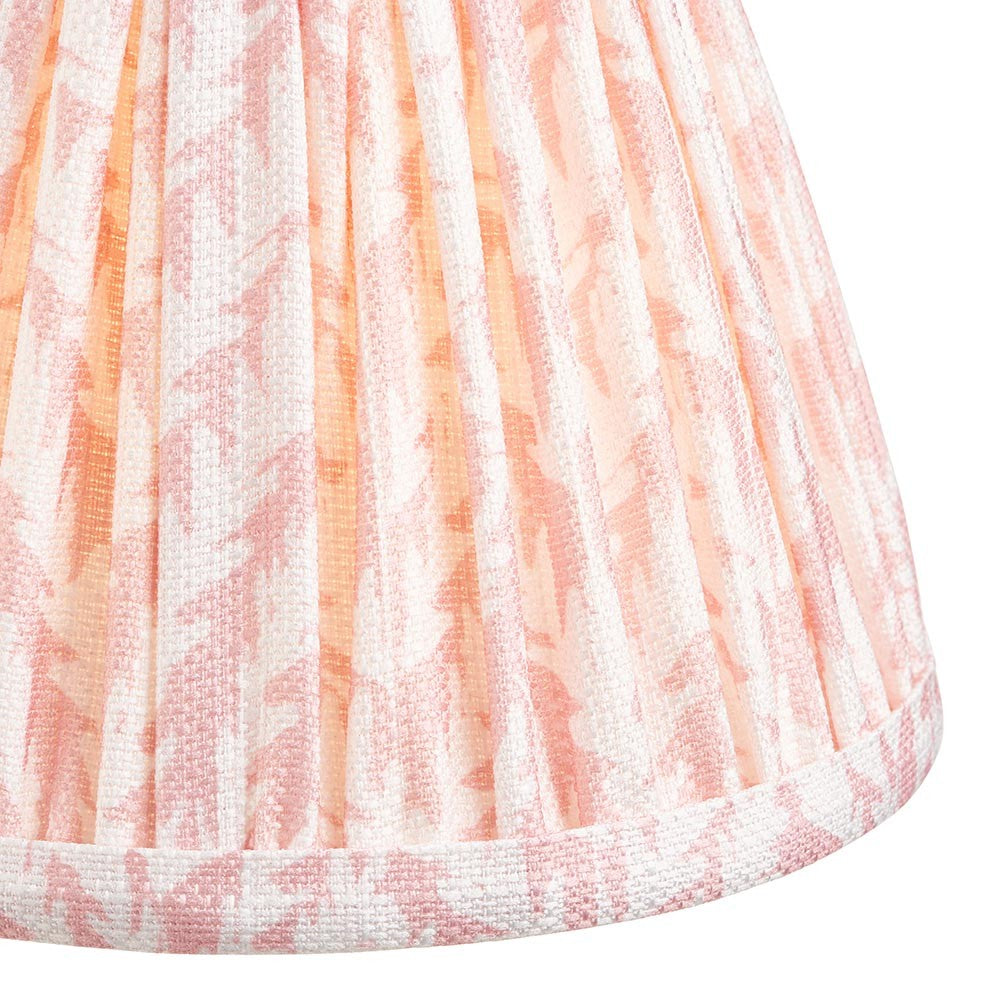 Close-up of the Caldgrove 16cm tapered lamp shade in Peachy Keen, showing pleated faux linen fabric with a leaf pattern and taped edge trim.