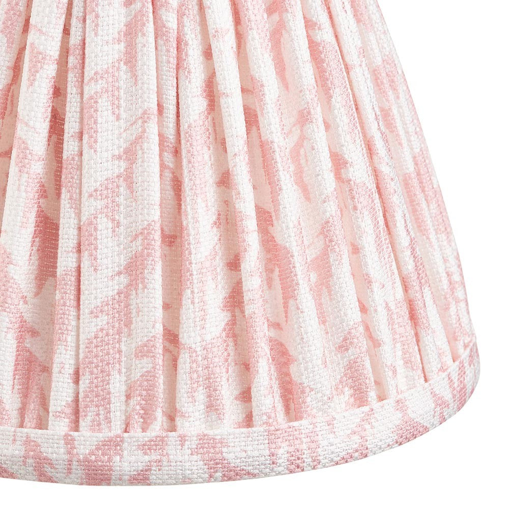 Close-up of the Caldgrove 16cm tapered lamp shade in Peachy Keen, showing pleated faux linen fabric with a leaf pattern and taped edge trim.