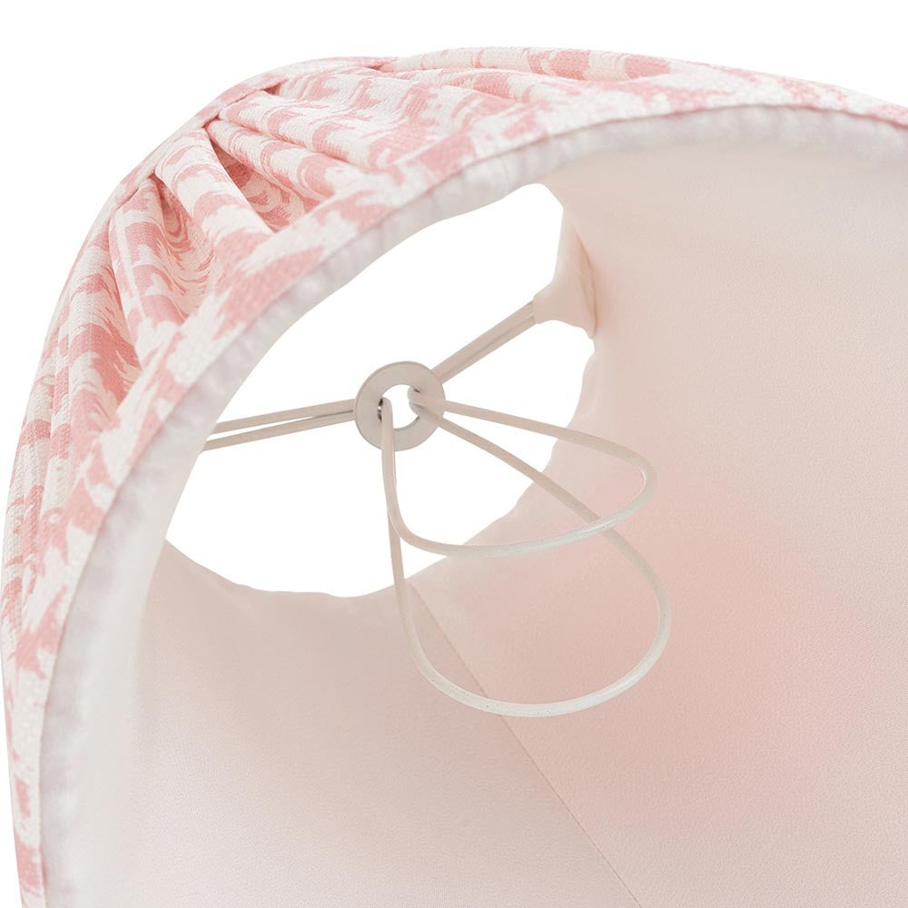 Close-up of the Caldgrove 16cm tapered lamp shade's inner frame, showing pleated peachy-pink fabric, taped edge, plain lining, and support ring.
