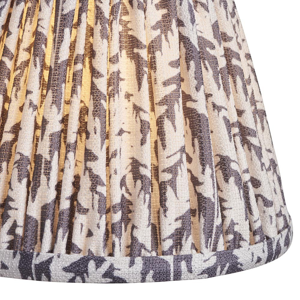 Close-up of Endon Caldgrove 16cm tapered lamp shade in pearl grey, showing pleated faux linen with a grey leaf print and taped lower edge.