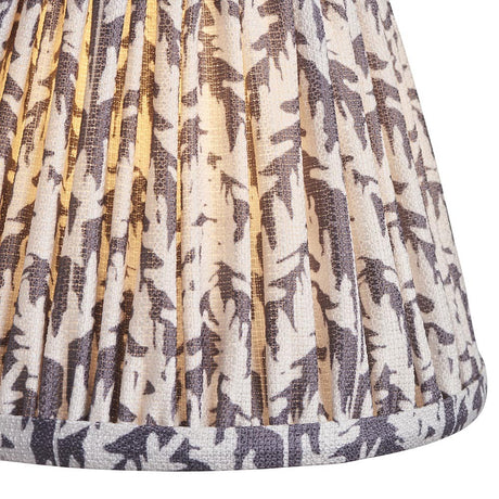 Close-up of Endon Caldgrove 16cm tapered lamp shade in pearl grey, showing pleated faux linen with a grey leaf print and taped lower edge.