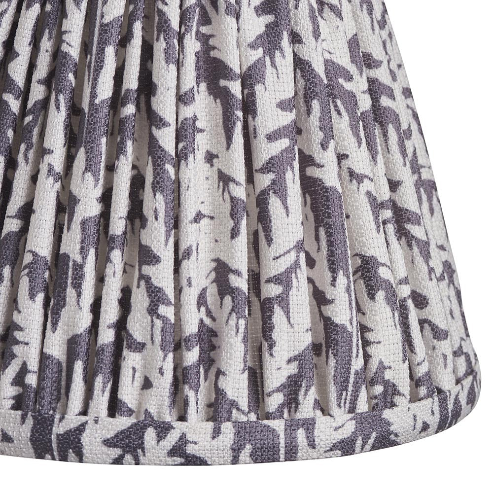 Close-up of Endon Caldgrove 16cm tapered lamp shade in pearl grey, showing pleated faux linen with a soft leaf print and taped edge detail.