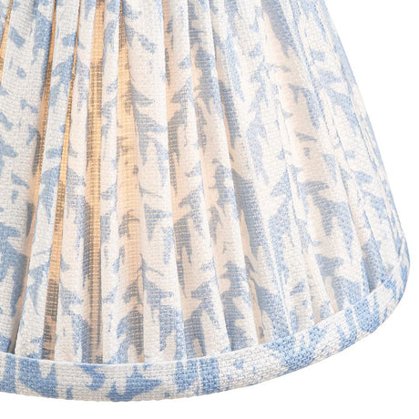 Close-up of the Endon Caldgrove 16cm tapered lamp shade in shell bay blue, showing pleated faux linen with a botanical leaf print and taped edging.