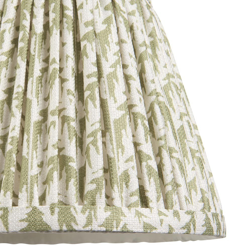 Close-up of Endon Caldgrove 20cm tapered lamp shade in herb garden green, showing pleated faux linen with leaf print and taped bottom edge.