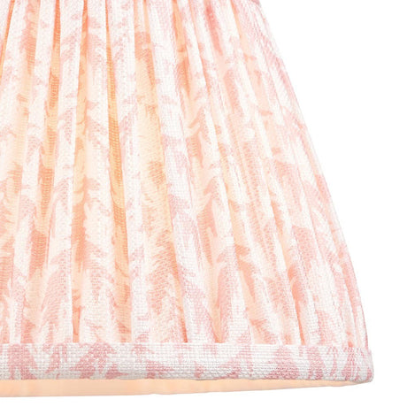 Close-up of Endon Caldgrove 20cm tapered lamp shade in Peachy Keen, showing gathered pleated faux linen with a soft pink leaf print and taped hem.