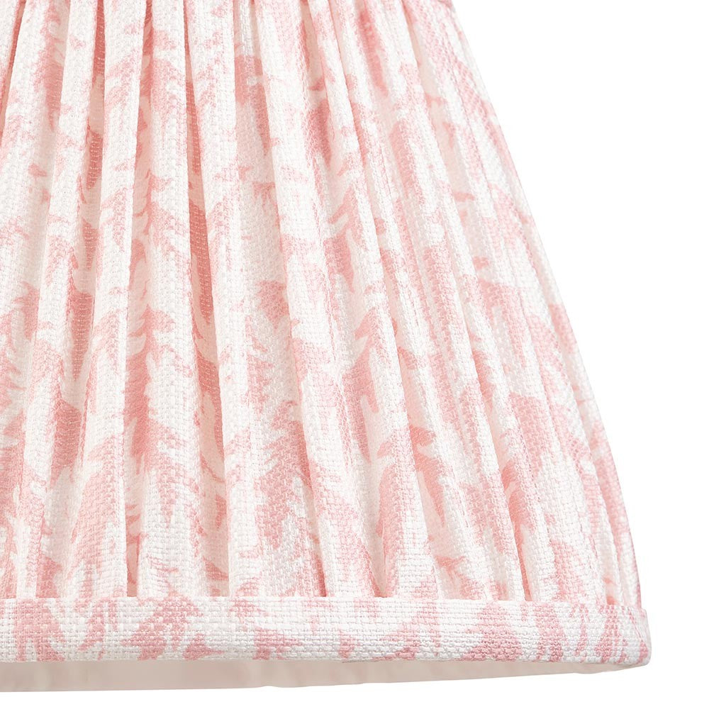Close-up of Endon Caldgrove 20cm tapered lamp shade in Peachy Keen, showing gathered pleated faux linen with a soft pink leaf print and taped edge.