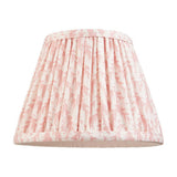 Endon Caldgrove 20cm tapered lamp shade in Peachy Keen, pleated faux linen with pink leaf print and taped edging, shown on a white background.