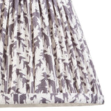 Endon Caldgrove 20cm tapered lamp shade in pearl grey, close-up of the pleated faux linen with a printed leaf pattern and taped bottom edge.