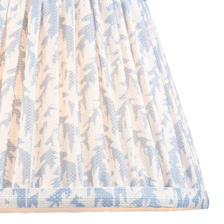 Endon Caldgrove 20cm tapered lamp shade in shell bay blue, close-up of the pleated faux linen with blue leaf print and taped edge trim.
