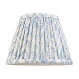 Endon Caldgrove 20cm tapered lamp shade in shell bay blue, with pleated faux linen and a leaf print, taped edges, shown on a plain white background.