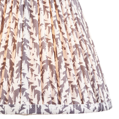 Close-up of Endon Caldgrove 25cm tapered lamp shade in pearl grey, showing gathered pleated faux linen with a soft botanical leaf print and taped edge.