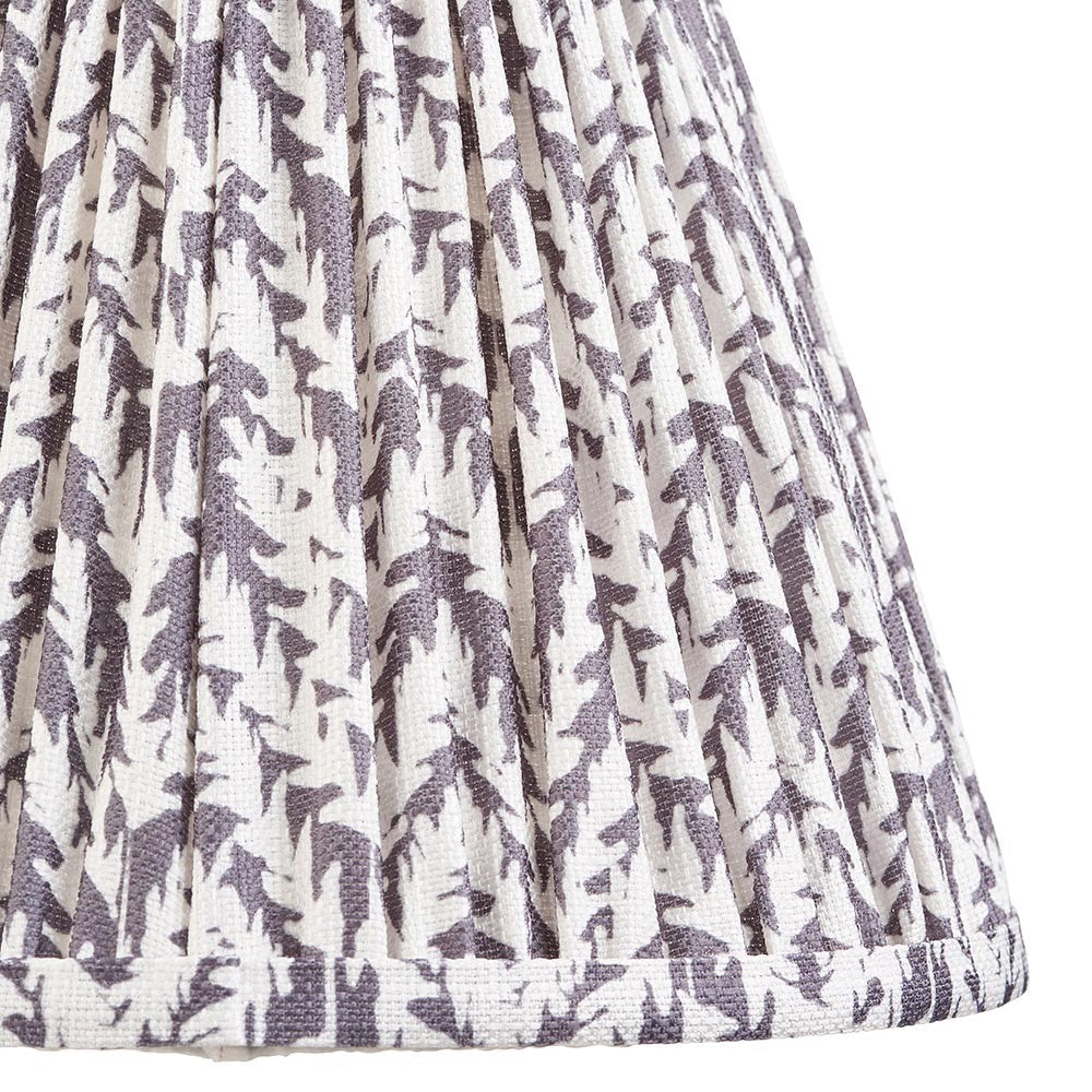 Close-up of Endon Caldgrove 25cm tapered lamp shade in pearl grey, showing pleated faux linen with a soft botanical leaf print and taped edge.
