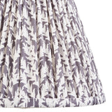 Close-up of Endon Caldgrove 25cm tapered lamp shade in pearl grey, showing pleated faux linen with a soft botanical leaf print and taped edge.