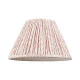 Endon Caldgrove 30cm tapered lamp shade in peachy keen pink faux linen with a pleated leaf print and taped edge, shown on a plain white background.