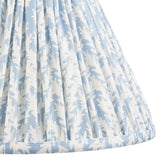 Close-up of Endon Caldgrove 30cm tapered lamp shade in shell bay blue, showing pleated faux linen with a soft botanical leaf print.