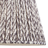 Endon Caldgrove 35cm tapered lamp shade in pearl grey faux linen, shown close-up with gathered pleats and a subtle botanical leaf print.