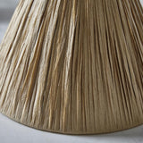 Close-up of the Caldwood 25cm tapered lamp shade in natural raffia, showing pleated woven texture in an earthy brown tone.