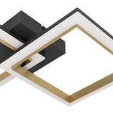 Close-up of the Calliera LED flush ceiling light, showing overlapping square frames in black with brushed brass inner edges and a white diffuser, mounted on a black base.