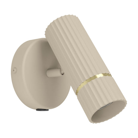 Caminia Wall Light in sand with a fluted cylindrical steel head, brushed brass ring detail, and round wall plate with GU10 spotlight, shown on a white background.