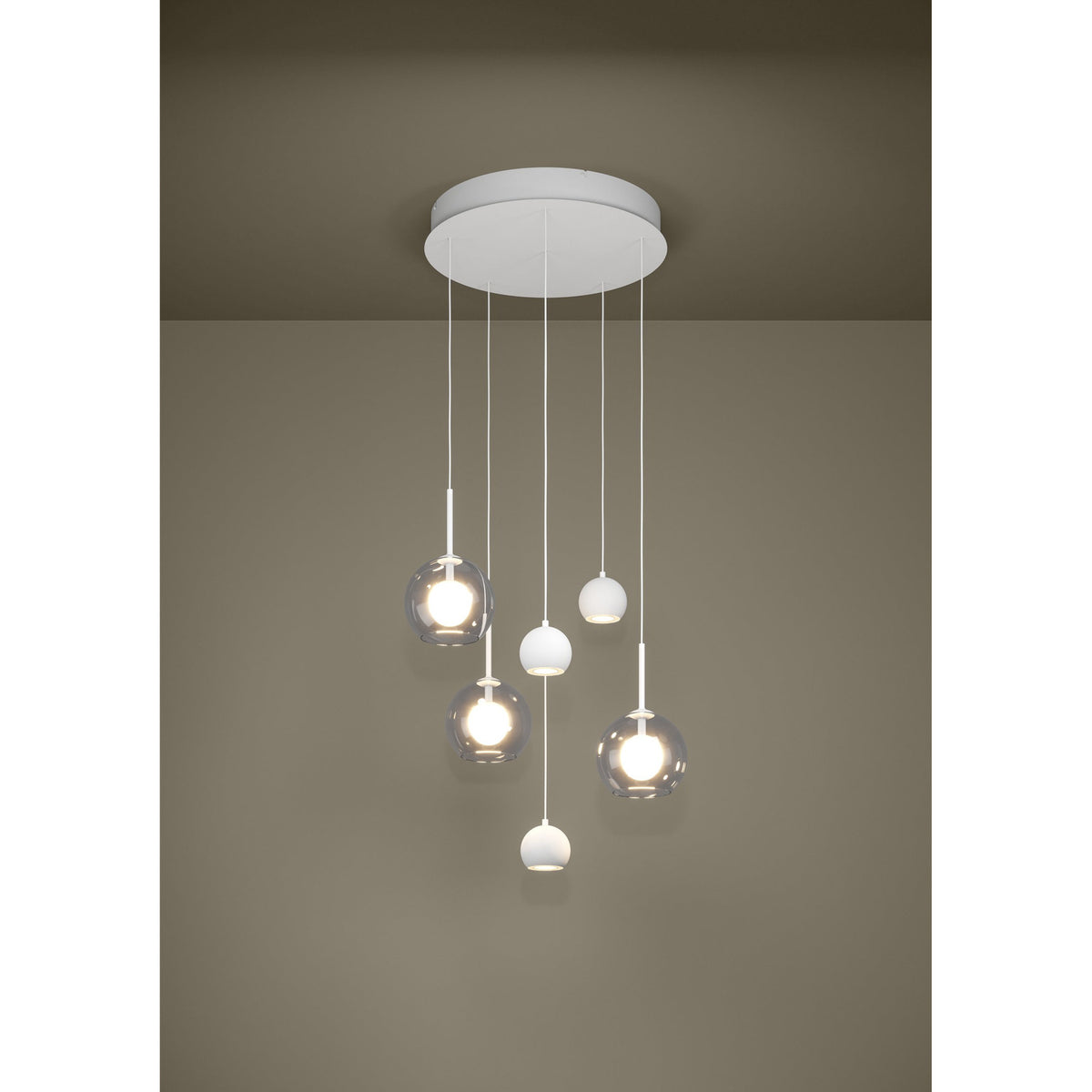 Caprecano 6-light cluster pendant in white, with three small white ball shades and three clear glass globes at staggered heights from a round white ceiling plate.