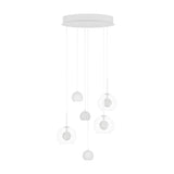 Caprecano six-light pendant in white with three small ball shades and three clear glass globes at staggered heights, mounted on a round white ceiling plate.