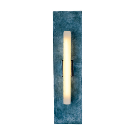 Capua Ceramic Wall Light in Blue Earth glaze, a tall rectangular mottled blue ceramic plate holding an illuminated tube bulb on a matt black bracket, shown on a white background.