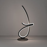 Cardoncito LED Table Lamp in black steel, a looping ribbon form on a round disc base with an illuminated white diffuser edge, shown against a plain grey background.
